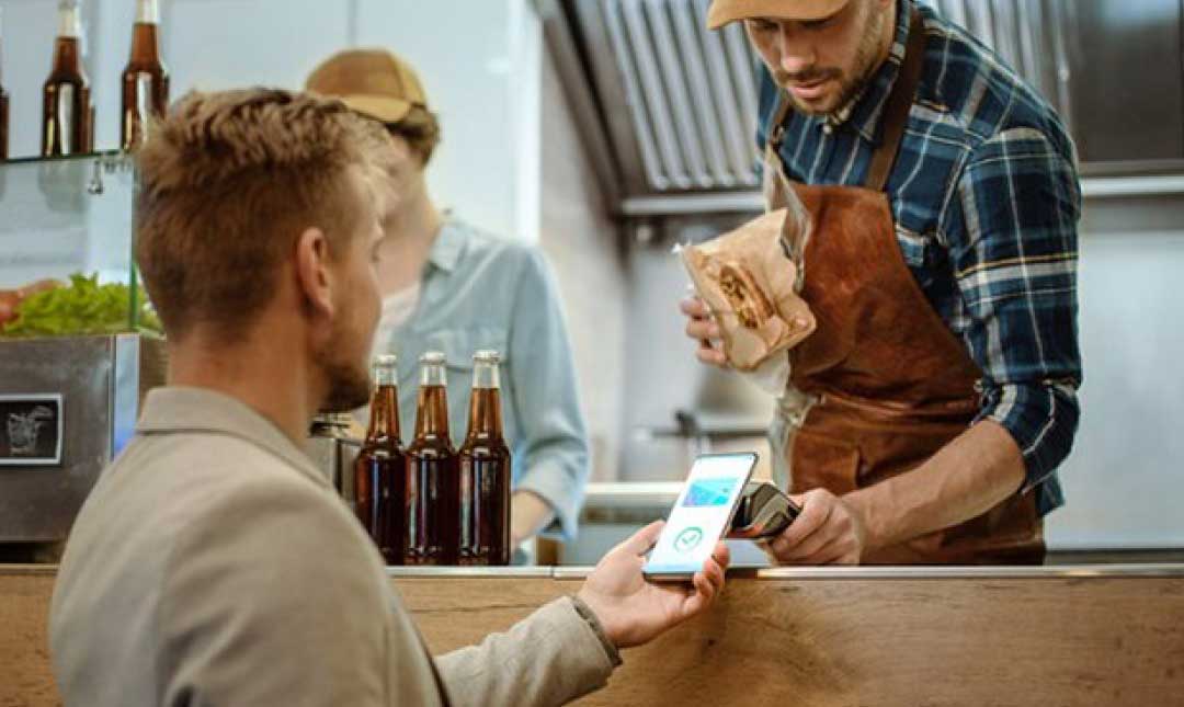 A man order and pay with pos at food truck